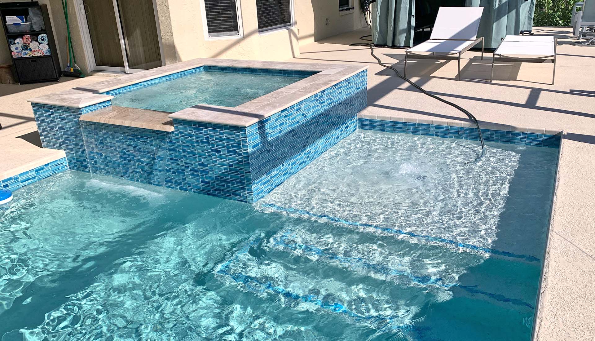 Glass tile spa and sunshelf by Pool and Deck Concepts, Naples, FL