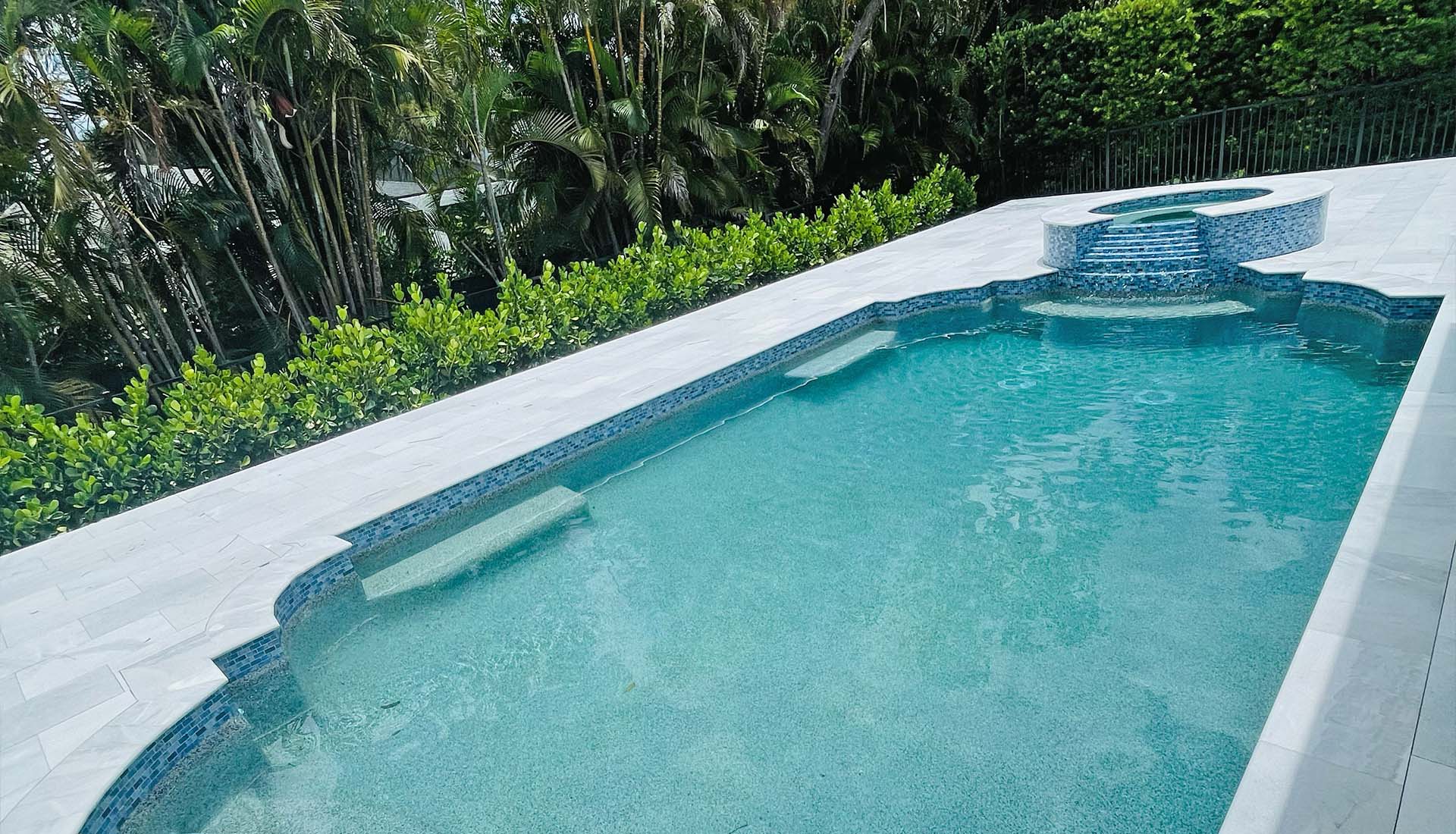 Tiered spillway spa in full pool and deck renovation by Pool and Deck Concepts, Naples, FL