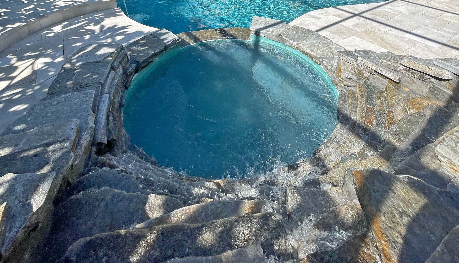 Natural stone tiered spillway by Pool and Deck Concepts, Naples, FL