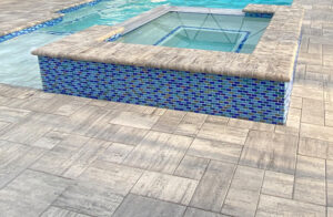 Cement pavers are an economical and beautiful way to brighten any pool deck.
